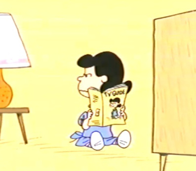 Lucy van Pelt reading a TV Guide