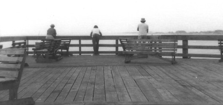 Three men at the rail, fishing (black&white)