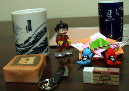 group of objects, including two tea-cups 
and a Muji eraser Japan 2011 souvenirs