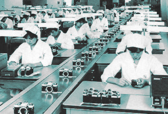 women on a camera assembly line